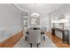 Elegant dining room with decorative molding, a chandelier, and wood floors at 7005 Camrose Crossing Ln, Matthews, NC 28104
