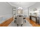 Refined dining room with classic wainscoting and a stylish light fixture at 7005 Camrose Crossing Ln, Matthews, NC 28104