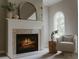 A charming fireplace with marble surround and hearth adds warmth to the space at 7005 Camrose Crossing Ln, Matthews, NC 28104