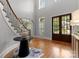 Grand foyer featuring a high ceiling, hardwood floors, and a curved staircase at 7005 Camrose Crossing Ln, Matthews, NC 28104