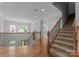 Elegant foyer with hardwood floors, staircase, and wrought iron banister at 7005 Camrose Crossing Ln, Matthews, NC 28104