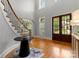 Grand foyer with a staircase, high ceilings, hardwood floors, and double front doors at 7005 Camrose Crossing Ln, Matthews, NC 28104