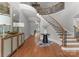 Grand foyer boasts a curved staircase, hardwood floors, and elegant decor at 7005 Camrose Crossing Ln, Matthews, NC 28104