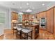 Light-filled kitchen boasts custom cabinets, a kitchen island, and stainless steel appliances at 7005 Camrose Crossing Ln, Matthews, NC 28104