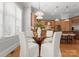 Bright kitchen with wooden cabinets, stainless appliances, and a glass-top dining table at 7005 Camrose Crossing Ln, Matthews, NC 28104