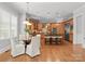 Eat-in kitchen features an island with counter seating, pendant lights, and stainless appliances at 7005 Camrose Crossing Ln, Matthews, NC 28104