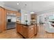 Open-concept kitchen with an island, stainless steel appliances, and access to living areas at 7005 Camrose Crossing Ln, Matthews, NC 28104