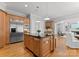 A large kitchen with a kitchen island that flows into the dining area and living room at 7005 Camrose Crossing Ln, Matthews, NC 28104
