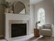 Cozy living room featuring a fireplace, neutral decor, and an arched window at 7005 Camrose Crossing Ln, Matthews, NC 28104