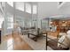 Spacious living room with tall windows flows into the dining area and kitchen, great for entertaining at 7005 Camrose Crossing Ln, Matthews, NC 28104