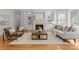 Bright living room features a fireplace, built-in shelving, and hardwood flooring throughout at 7005 Camrose Crossing Ln, Matthews, NC 28104