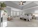 A serene main bedroom has a fireplace and seating area with large windows at 7005 Camrose Crossing Ln, Matthews, NC 28104