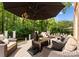 Inviting outdoor seating area on a wooden deck, with brick home, lush greenery, and relaxing atmosphere at 7005 Camrose Crossing Ln, Matthews, NC 28104