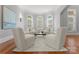 Cozy sitting room featuring four plush chairs and a center table, flooded with natural light at 7005 Camrose Crossing Ln, Matthews, NC 28104
