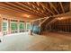 Large unfinished room with natural light offers endless possibilities to create a custom space to your liking at 7005 Camrose Crossing Ln, Matthews, NC 28104