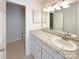 Bathroom featuring granite counters, white cabinets, tile floors, and a sink at 7116 Winery Ln, Charlotte, NC 28227