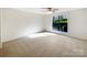 Bright bedroom with a large window offering natural light and neutral carpet at 7116 Winery Ln, Charlotte, NC 28227