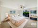 Serene bedroom with a large window, a ceiling fan, and neutral decor for a relaxing atmosphere at 7116 Winery Ln, Charlotte, NC 28227