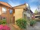 Inviting townhome exterior with a well-maintained lawn and vibrant pink flowering bushes at 7116 Winery Ln, Charlotte, NC 28227