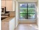 Bright kitchen with granite countertops, white cabinets, and a large window offering scenic views at 7116 Winery Ln, Charlotte, NC 28227