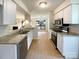 Well-lit kitchen features granite countertops, white cabinets, and stainless steel appliances at 7116 Winery Ln, Charlotte, NC 28227