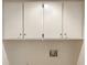 Laundry area with upper cabinets, washer and dryer hookups, and white walls at 7116 Winery Ln, Charlotte, NC 28227