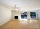 Spacious living room boasts wood floors, a fireplace, and sliding glass doors to outdoor living space at 7116 Winery Ln, Charlotte, NC 28227