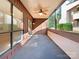Covered patio with sliding glass door, wood beams and a ceiling fan at 7116 Winery Ln, Charlotte, NC 28227