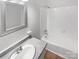 Bright bathroom features tub/shower combo and a large mirror at 8026 Regent Park Ln, Charlotte, NC 28210