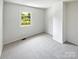 Bedroom with neutral carpet and a large window offering a view of the outdoors at 8026 Regent Park Ln, Charlotte, NC 28210