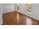 Bright bedroom featuring hardwood floors and large windows offering plenty of natural light at 8026 Regent Park Ln, Charlotte, NC 28210