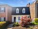 Charming townhome featuring a picket fence and a vibrant red Japanese maple at 8026 Regent Park Ln, Charlotte, NC 28210