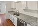 Kitchen with stainless steel sink, granite countertops, and white cabinets at 8026 Regent Park Ln, Charlotte, NC 28210