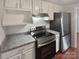 Bright kitchen featuring granite countertops and stainless steel appliances at 8026 Regent Park Ln, Charlotte, NC 28210