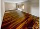 Bright living room with wood-look flooring and double doors leading to the outside at 8026 Regent Park Ln, Charlotte, NC 28210