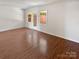 Bright living room features laminate floors, a French door, and lots of natural light at 8026 Regent Park Ln, Charlotte, NC 28210