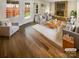 Bright living room featuring a stone fireplace, hardwood floors, and modern furnishings at 8026 Regent Park Ln, Charlotte, NC 28210