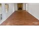 Living room with wood floors and a stone fireplace feature at 8026 Regent Park Ln, Charlotte, NC 28210