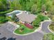 Aerial view of community clubhouse featuring a pool, playground, ample parking, and lush landscaping at 8428 Westmoreland Lake Dr, Cornelius, NC 28031