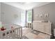 Sweet Bedroom with a crib, changing table, and soft, colorful decor at 8428 Westmoreland Lake Dr, Cornelius, NC 28031