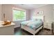 Charming bedroom with a bright window, wooden floors, and coastal-inspired decor at 8428 Westmoreland Lake Dr, Cornelius, NC 28031