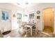 Cozy dining area with a gray table, white chairs, and natural light at 8428 Westmoreland Lake Dr, Cornelius, NC 28031