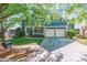 Beautiful two-story blue home with a well-manicured lawn and a long driveway leading to the garage at 8428 Westmoreland Lake Dr, Cornelius, NC 28031