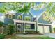 Charming two-story blue home with a welcoming front porch and an attached two-car garage at 8428 Westmoreland Lake Dr, Cornelius, NC 28031