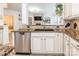 Modern kitchen featuring stainless steel appliances, granite countertops and open to living area at 8428 Westmoreland Lake Dr, Cornelius, NC 28031