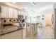Well-lit kitchen boasts white cabinets, granite countertops, and stainless steel appliances at 8428 Westmoreland Lake Dr, Cornelius, NC 28031