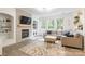 Bright living room featuring a fireplace, neutral decor, and large windows offering natural light at 8428 Westmoreland Lake Dr, Cornelius, NC 28031