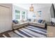 Bright living room with beach decor, comfortable seating, and a stylish striped rug at 8428 Westmoreland Lake Dr, Cornelius, NC 28031