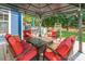 Outdoor seating with red cushioned chairs, perfect for relaxing in a lovely outdoor space at 8428 Westmoreland Lake Dr, Cornelius, NC 28031