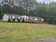 Well-maintained single story home with a wheelchair ramp and lush green lawn at 8813 Summerhill Dr, Waxhaw, NC 28173